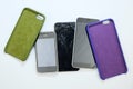 smartphone cases and three broken smartphones