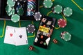 Smartphone and casino chips stacking on a green felt Royalty Free Stock Photo