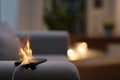 Smartphone catching fire while charging on sofa in living room causing fire accident Royalty Free Stock Photo