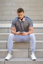 Smartphone cell phone listening to music portrait format young latin man listen