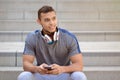 Smartphone cell phone listening to music young latin man looking up listen Royalty Free Stock Photo