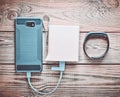 Smartphone is charged from the power bank, smart bracelet Royalty Free Stock Photo