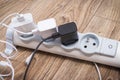 Smartphone chargers connected to electrical power strip. Various devices charging