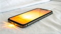 Smartphone charging on bed with sunset screen display Royalty Free Stock Photo