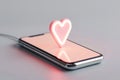 A smartphone is charging, displaying a glowing digital heart notification on its screen. The heart radiates a soft pink light Royalty Free Stock Photo
