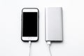Smartphone charging with power bank on white background Royalty Free Stock Photo