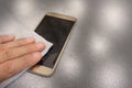 Smartphone cleaning dirty screen with blue microfiber fabric