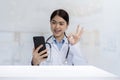 Smartphone concept connected with online technology communication doctor holding a smartphone chatting online. Treat patients via Royalty Free Stock Photo