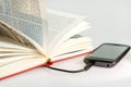 Smartphone connected to a book Royalty Free Stock Photo