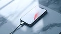 Smartphone Connected to a Charger on a Minimalistic Desk
