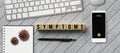 Smartphone with cubes and the word SYMPTOMS surrounded by keyboard, notepad and a pen Royalty Free Stock Photo