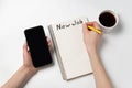 Smartphone, cup of coffee and Notepad with words New job. Planning and strategy concept. Copy space Royalty Free Stock Photo