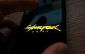 Smartphone with cyberpunk game logo on the screen.