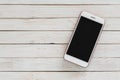 Smartphone with dark screen on white wood texture background Royalty Free Stock Photo