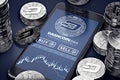 Smartphone with Dashcoin trading chart on-screen among piles of silver Dashcoins.