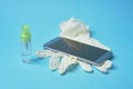 Smartphone disinfection. sanitizer virus spray. blue background Royalty Free Stock Photo