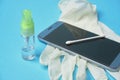 Smartphone disinfection. sanitizer virus spray. blue background Royalty Free Stock Photo