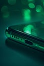 Smartphone display, emphasizing sleek design and innovative screen technology, green bokeh in the background Royalty Free Stock Photo