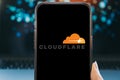 Riga, Latvia - February 04, 2026:Smartphone displaying the Cloudflare logo on a black screen. Royalty Free Stock Photo