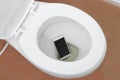 Smartphone dropped into toilet Royalty Free Stock Photo