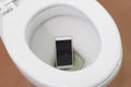 Smartphone dropped into toilet Royalty Free Stock Photo