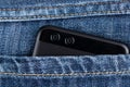 Smartphone with dual camera in back pocket of jeans Royalty Free Stock Photo