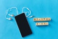 smartphone, earphones and digital detox words Royalty Free Stock Photo