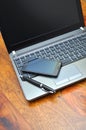 Smartphone and elegant pen on a laptop