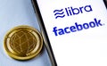 Smartphone with Facebook and Libra logo