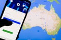 Smartphone with Facebook`s login screen against the map of Australia in the background. Facebook recently blocked users in Austral