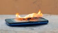 Smartphone on fire. The phone exploded from mishandling