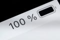 Smartphone full charged battery level indicator - 100 percent: close up macro