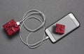 Smartphone and gift connected by a cable Royalty Free Stock Photo