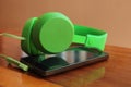 Smartphone and green headphone Royalty Free Stock Photo