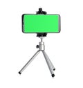 Smartphone with green screen fixed to tripod on white background. Mockup for design Royalty Free Stock Photo