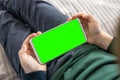 Smartphone with a green screen in hand child . Phone a for keying is holding kid top view close up Royalty Free Stock Photo