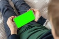 Smartphone with a green screen in hand child . Smartphone with a hromakey in the hands of a child