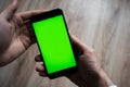 Smartphone with green screen for key chroma screen. Royalty Free Stock Photo