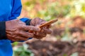 Smartphone in hand farmer man, smart phone in farm, technology farming lifestyle concept, mobile phone in worker hand using at