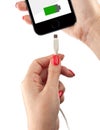 Smartphone in the hand of a woman. Connect the USB cable charger Royalty Free Stock Photo