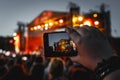 The smartphone in hands, shooting the concert stage