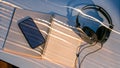 Smartphone and headphones on a notebook with light streaks on the table Royalty Free Stock Photo