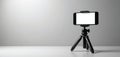 Smartphone held on compact, portable tripod. Modern gadget features adjustable mount for photo video creation. Black device set Royalty Free Stock Photo