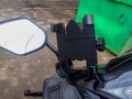 The smartphone holder is mounted on the motorcycle handlebar