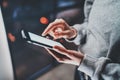 Smartphone holding in woman hands.Female fingers touching white blank screen.Horizontal, blurred background. Royalty Free Stock Photo