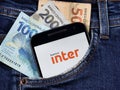 Smartphone with Inter bank logo on the screen in the pocket of jeans. Inter bank is a Brazilian multiple bank.