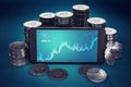 Smartphone with IOTA growth chart on-screen among piles of IOTA coins Royalty Free Stock Photo