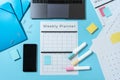 Smartphone, laptop, stationery and planner on blue pastel background Royalty Free Stock Photo