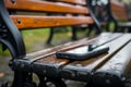 Smartphone left behind on park bench, a visual of forgetfulness