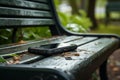 Smartphone left behind on park bench, a visual of forgetfulness